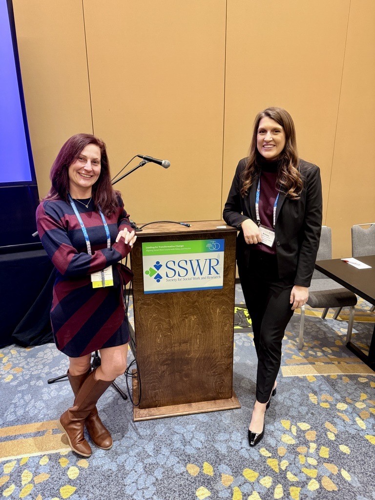 Brianna Lombardi and Danya Krueger standing next to a SSWR branded podium