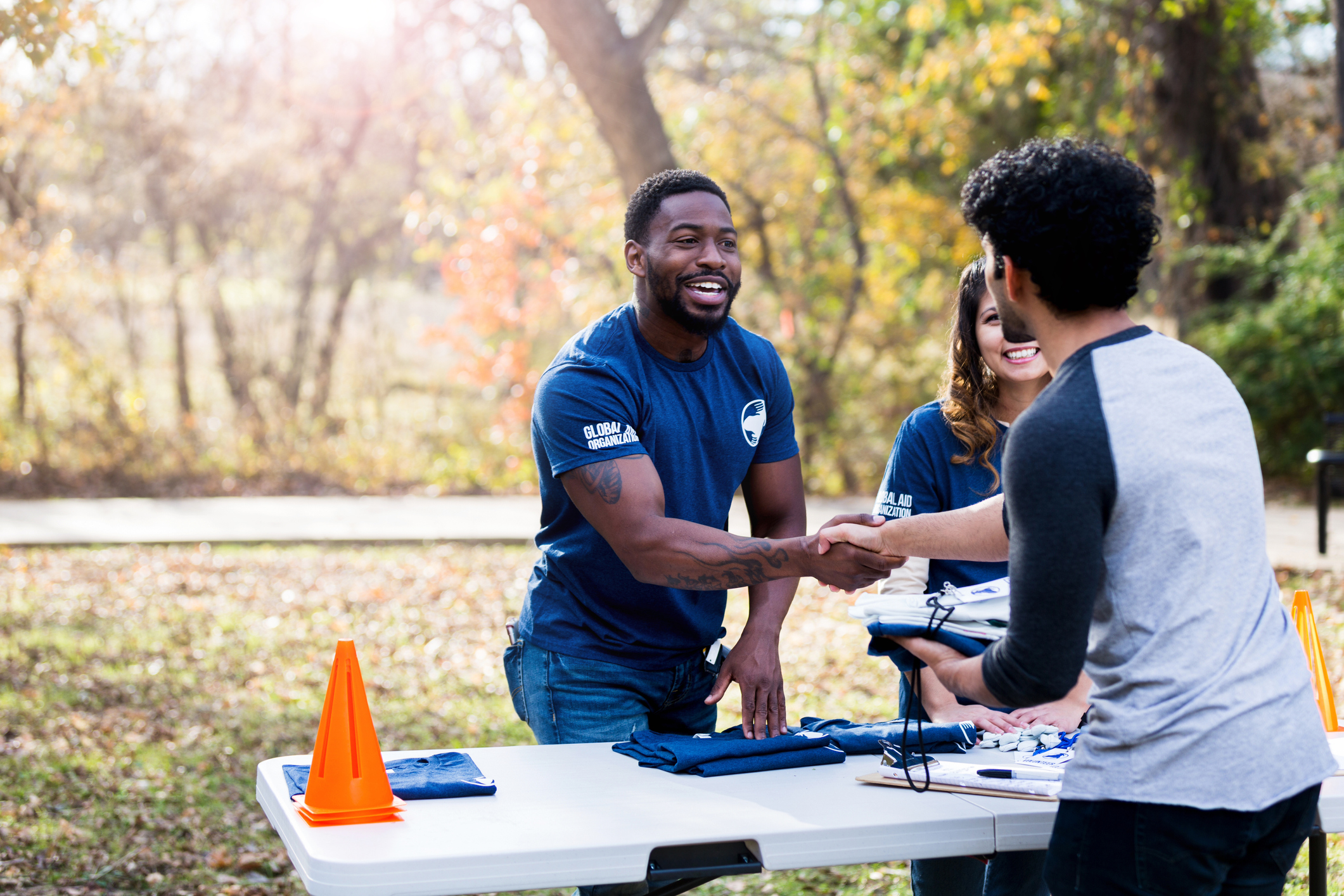 Harm reduction workers smiling and shaking hands with a man