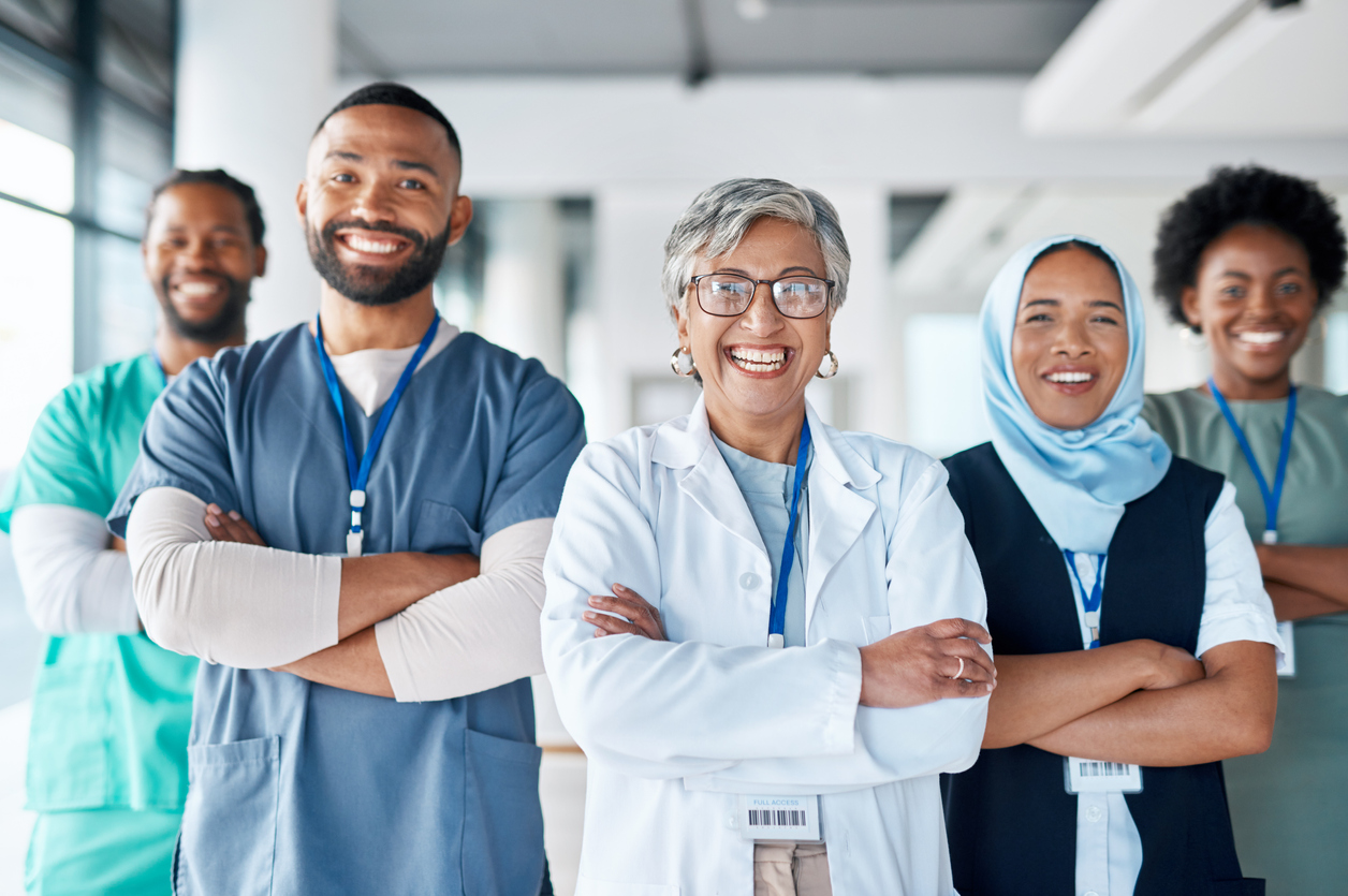 Group of medical professionals smiling with arms crossed