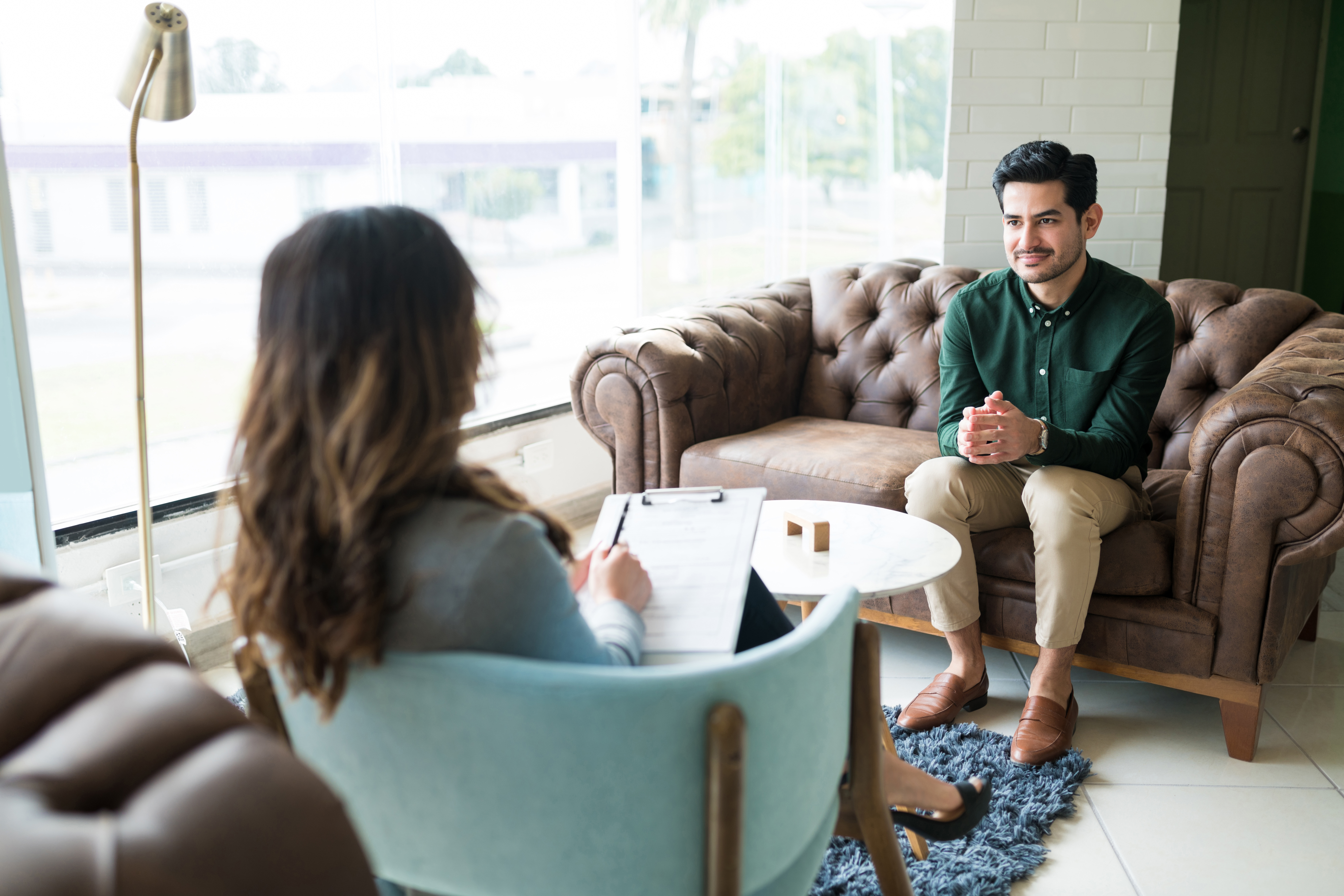 Provider talking with client on couch
