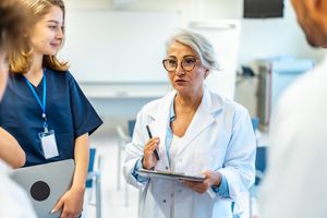 Worker with clipboard meeting with staff